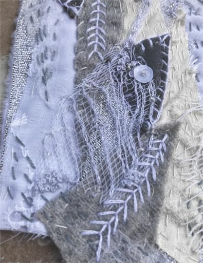 Hand embroidered art in shades of gray and white in an art journal