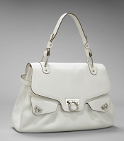 picture of a white handbag with a gold clasp and trim
