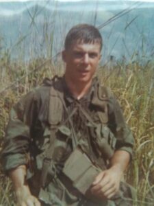 U.S. soldier in tall grass in Vietnam
