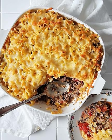 A dish of sauerkraut casserole with a portion taken out.