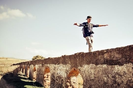man balancing on a wall. Release the discomfort