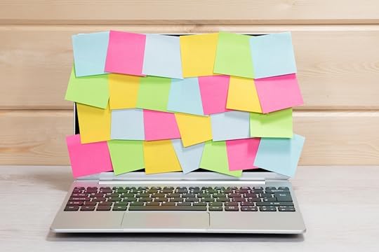 Open laptop covered in sticky notes