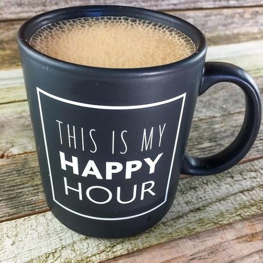 Black mug filled with coffee and printed with the words