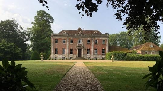 Photo of large, two-story Georgian set amidst large trees and a deep green lawn.