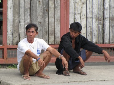 men sitting doing nothing