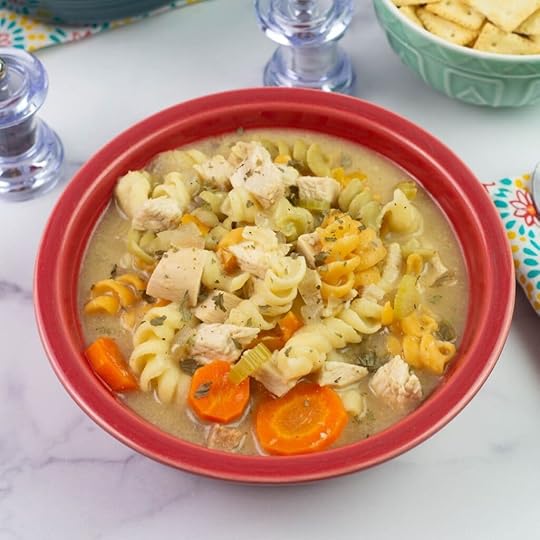 Cajun Chicken Noodle Soup served in a red bowl.