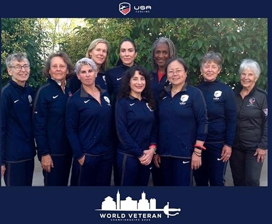 Ten older women in navy warm-ups lined up smiling at the camera, with the caption