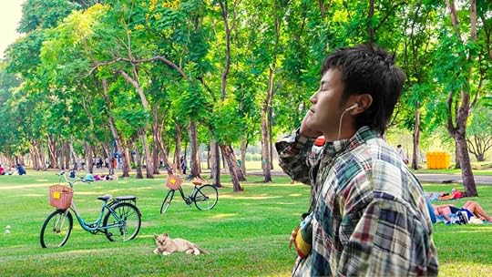 Listening to audiobooks while walking at the park.