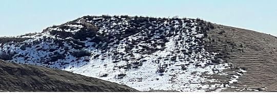 Hill with snow on one side and not on another side