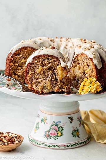 slice of hummingbird Bundt cake with icing and yellow flowers on cake stand.