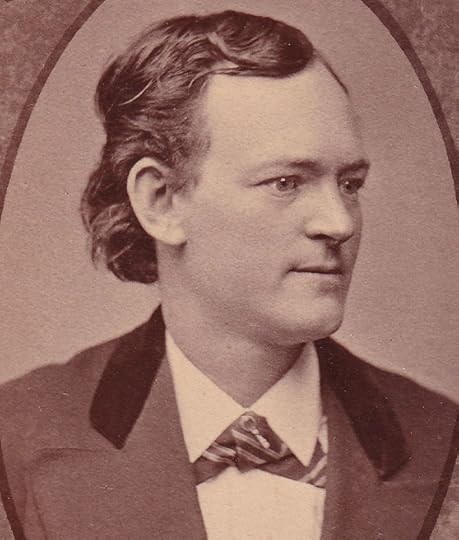 Sepia-toned head-and-shoulders of a young man wearing a suit and collar, looking to the right
