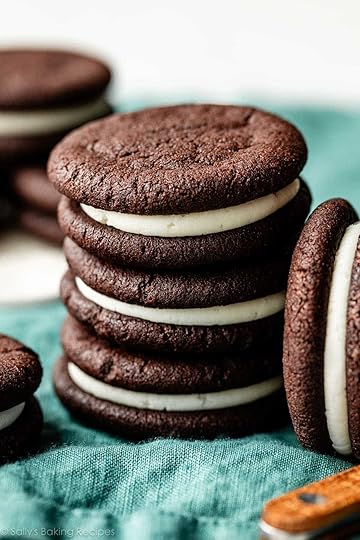 stack of 3 homemade Oreos on blue linen.