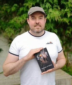 Rohan holding a copy of Cold Rising