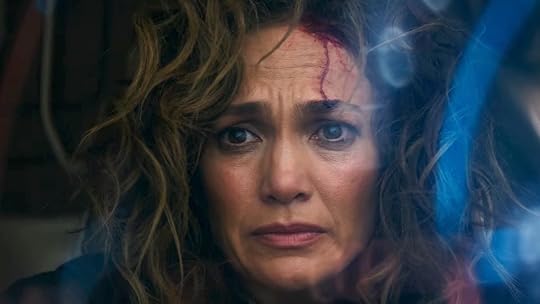 A bloodied Jennifer Lopez looks worried behind 3D computer images in Atlas from Netflix