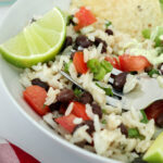 close up of black bean and rice salad with forkful atop bowl.