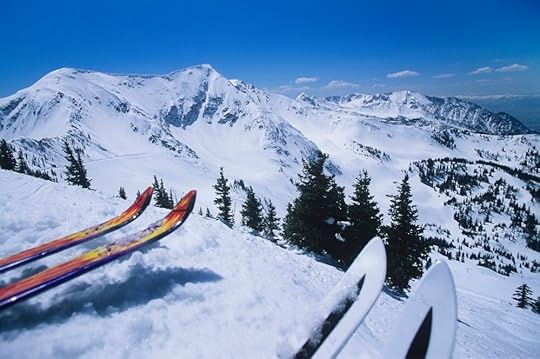 Two Pairs of Skis Overlooking Snowy Mountain Range