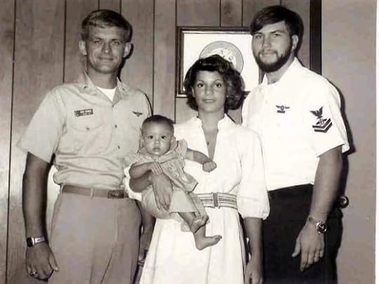 Navy officer with enlisted sailor and the sailor's wife and baby