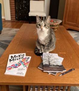 cat sitting with two books