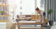 Woman neatening a living room