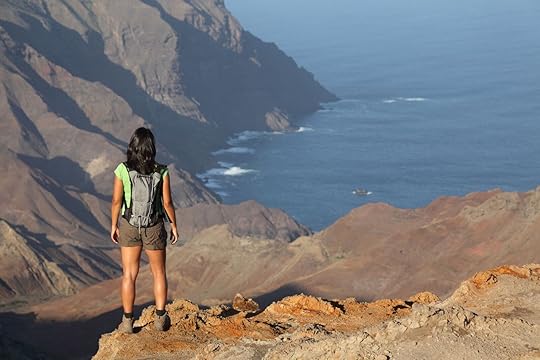 Woman hiking on top volcanic craters on St Helena