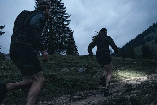 Two runnners in the mountains at sunrise