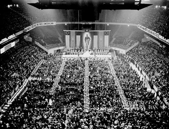 Two men in uniform working on a radio in the woods.