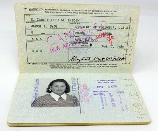 Two men in uniform working on a radio in the woods.