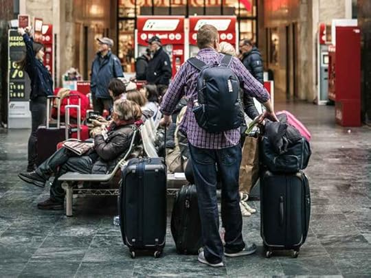 A traveler with several pieces of luggage
