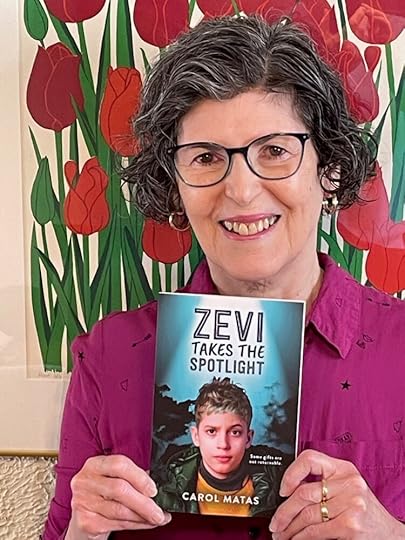 Author Carol Matas holds her new book, Zevi Takes the Spotlight
