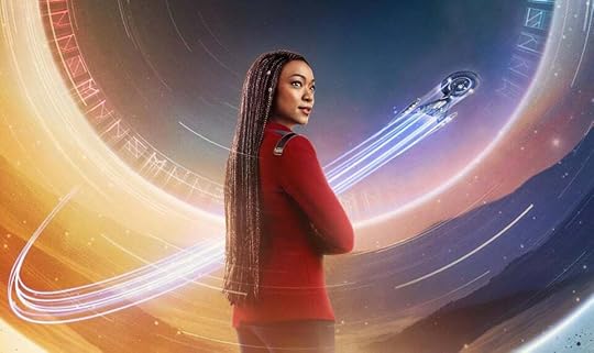 A detail from a poster for season 5 of Discovery, featuring Michael Burnham standing in front of a swirly circle full of weird symbols, with the Discovery zooming around in the background making Space Chemtrails