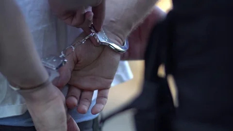 https://images.pond5.com/close-criminal-hands-handcuffs-police-footage-075461437_iconl.jpeg