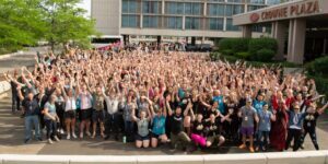 A huge group of gym owners smile outside the hotel at the Two-Brain Summit in Chicago.