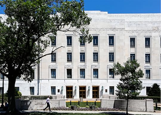 Photo of the front facade of the Adams Building on a sunny day.