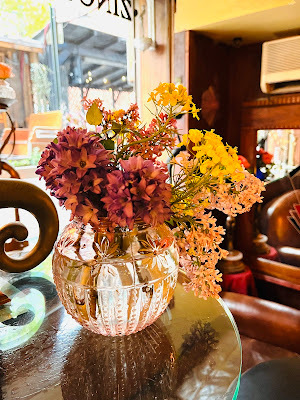 flower bouquet in glass bowl in front of window at ZINC BAR