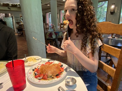 child eating strawberry pancakes at Comfort Cafe in San Antonio, Texas