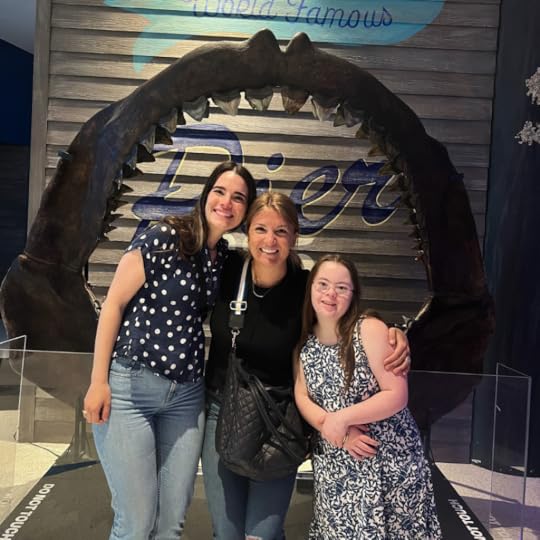 Penny stands in between two friends from Hope Heals camp. Behind them is a 