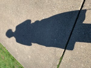 shadow of figure on sidewalk