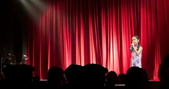 Learning to sing in front of a large group can be a great way to improve confidence. 