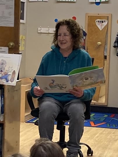 Jane reading THE TROUBLE WITH CAULIFLOWER and smiling