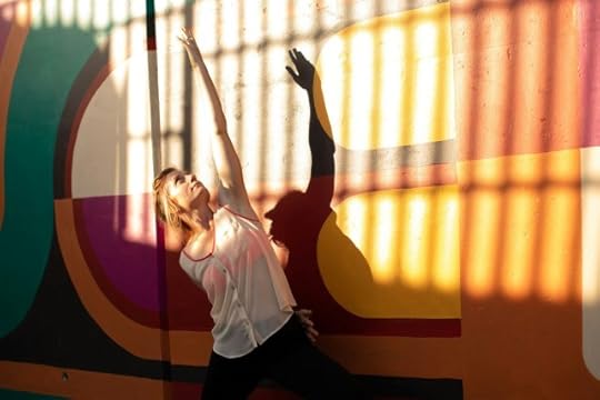 woman stretching in bars of light like an open cell