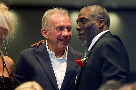 Joe Montana, left, speaks with John Taylor at the Bay...