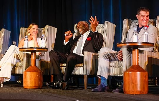 John Taylor, center, speaks during a panel next to Jenny...
