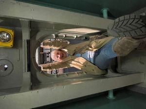 Author swinging through a sub hatch in the naval undersea museum