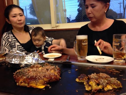 Enjoying cooking okonomiyaki with friends in Japan