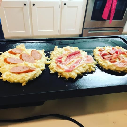 okonomiyaki topped 3 ways: smoked sausage, bacon, and a mix of meat