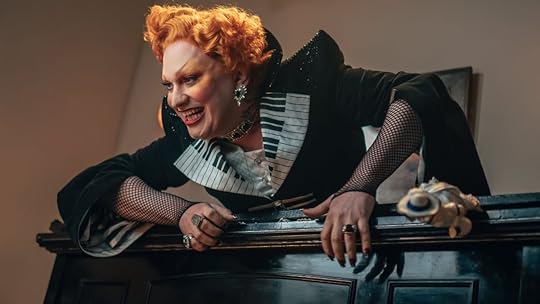 Jinkx Monsoon villain character Maestro leans over the top of a piano in doctor who episode