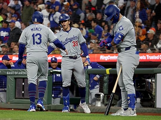 Los Angeles Dodgers’ Max Muncy #13 is congratulated by teammate...