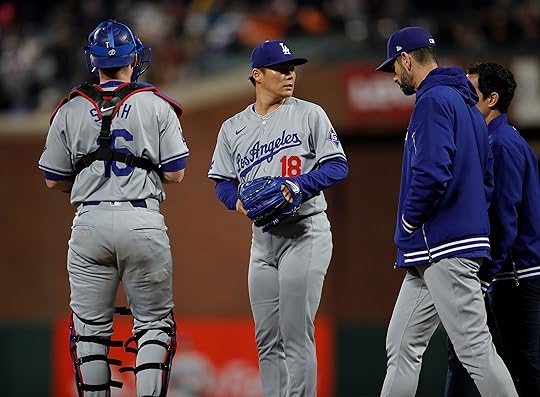 Los Angeles Dodgers starting pitcher Yoshinobu Yamamoto #18 is talked...