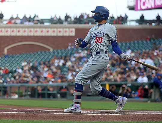 Los Angeles Dodgers’ Mookie Betts #50 watches the flight of...