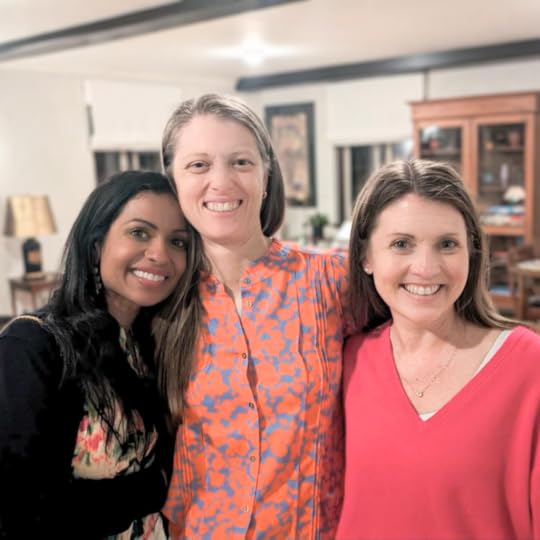 Amy Julia and two friends standing together in a living room